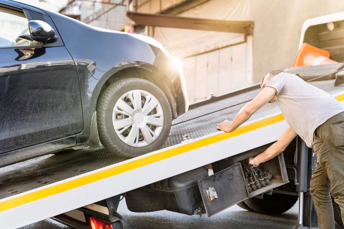 man lowering a truck ramp